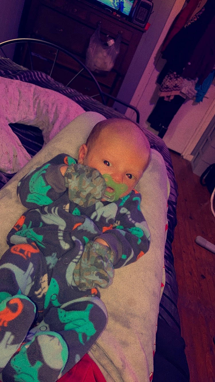 Brian is registered to the contest to win money with this photo: baby, baby_products, baby_toddler_clothing, bedtime, child, cloud, comfort, cool, flooring, fun, linens, mouth, nap, person, pink, purple, room, sitting, sky, stuffed_toy