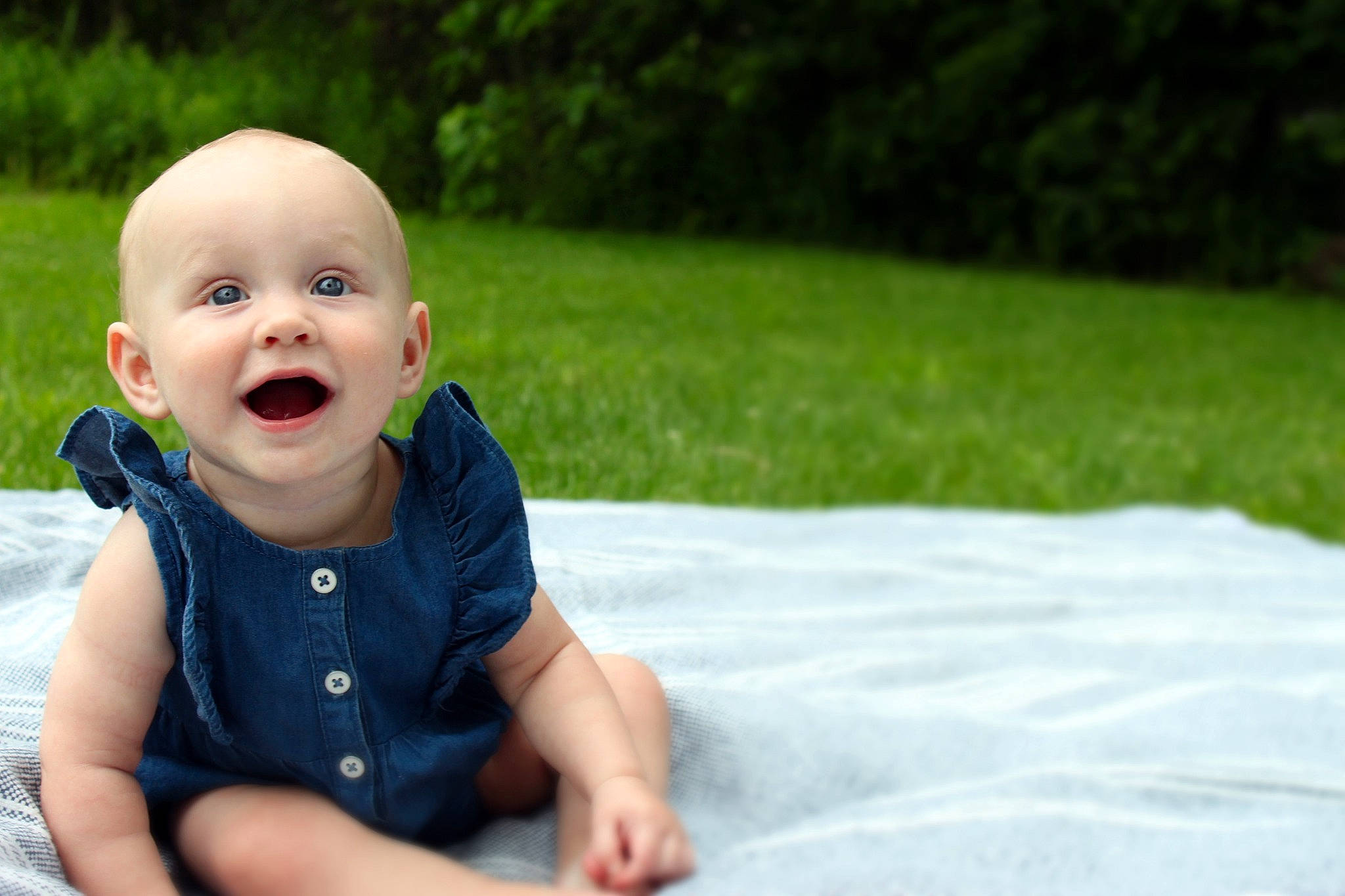 Emmy is registered to the contest to win money with this photo: baby, cheek, child, eye, face, facial_expression, fun, grass, green, head, lip, male, nose, people, person, photograph, sitting, skin, smile, summer