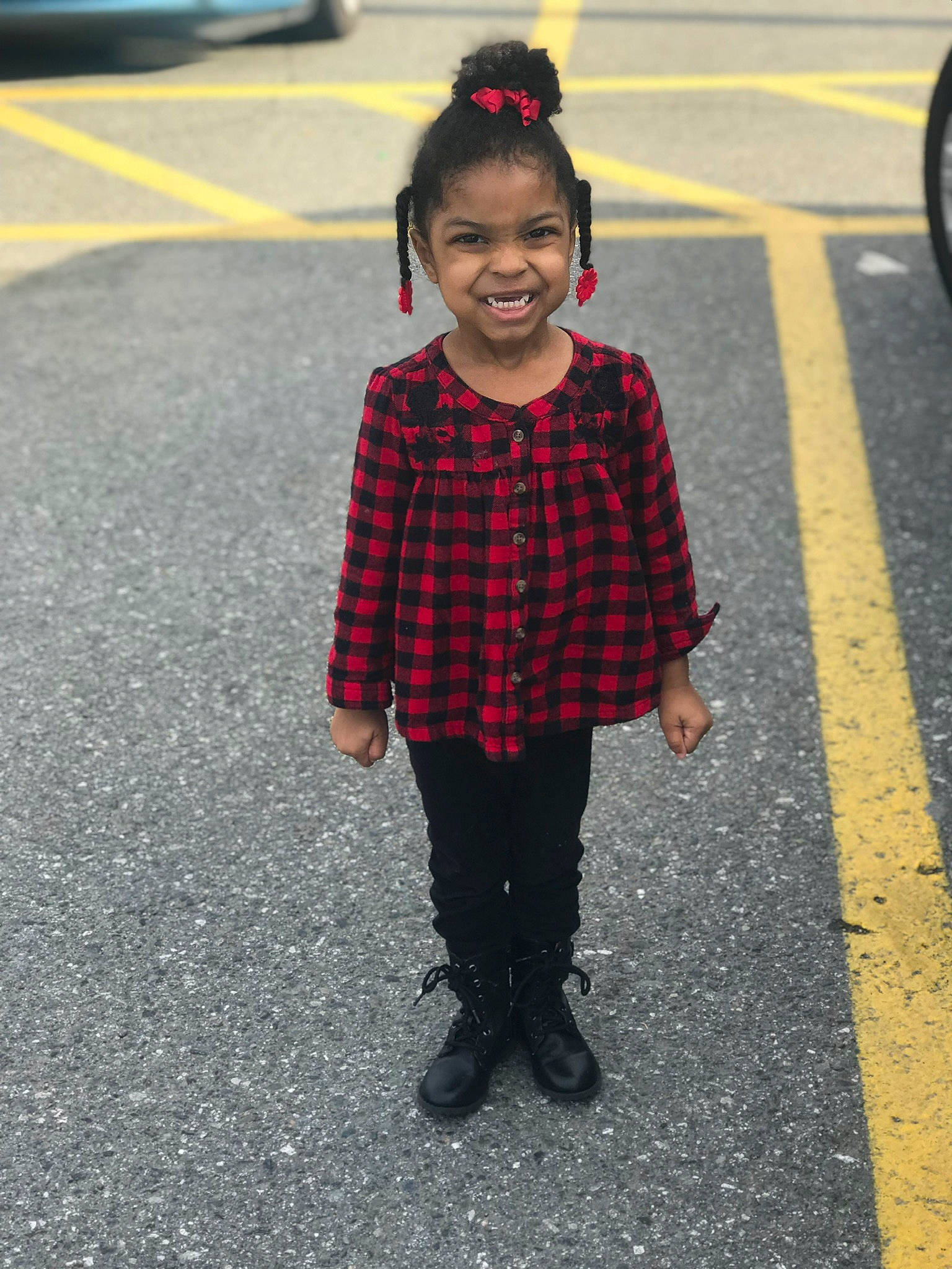 Mia is registered to the contest to win money with this photo: asphalt, child, design, face, fun, head, infrastructure, joy, outerwear, pattern, pedestrian, person, photography, plaid, road, smile, snapshot, standing, street, toddler