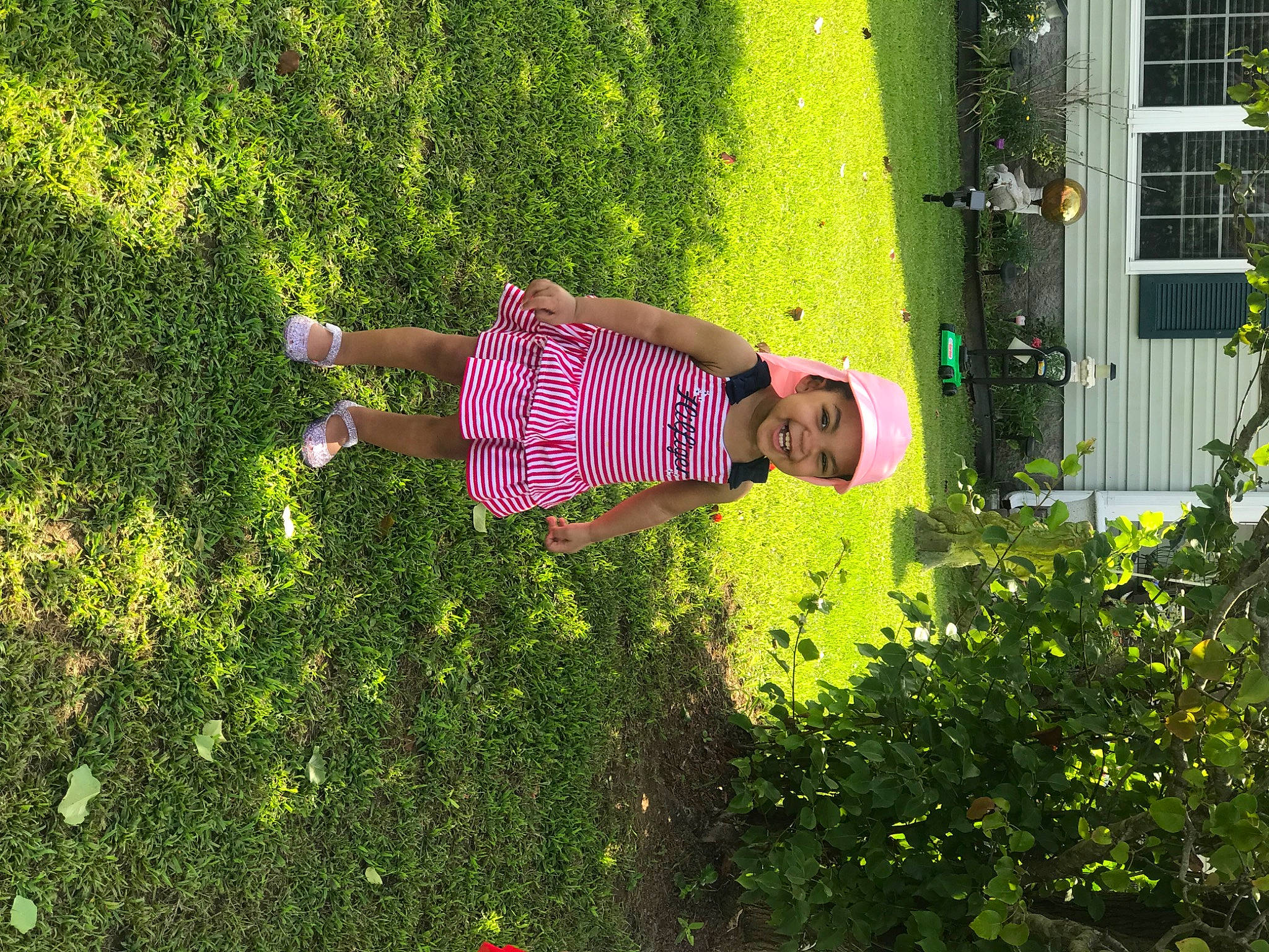 Zariah is registered to the contest to win money with this photo: botany, flower, garden, grass, green, groundcover, headwear, joy, leaf, person, pink, plant, shrub, tree