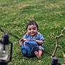 baby, child, grass, soccer_ball, outdoor, smiling, happy, barefoot, blue_clothing, playing, nature, cute, young, sitting, toy, greenery, face, person, daylight, fun