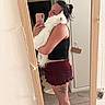 Polpetto participe au concours pour gagner de l'argent avec cette photo : woman, person, cat, white_cat, fluffy_cat, pet, mirror_selfie, selfie, indoors, bathroom, mirror, phone, long_hair, bun, black_top, skirt, tattoo, cuddling, standing, home_decor