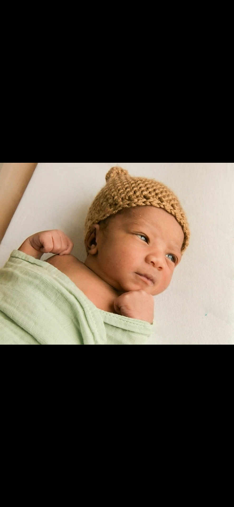Ry is registered to the contest to win money with this photo: baby, blanket, child, cute, expression, face, hand, headwear, indoors, infant, knitted_hat, newborn, peaceful, portrait, resting, skin, sleepwear, soft_light, wrapped, young