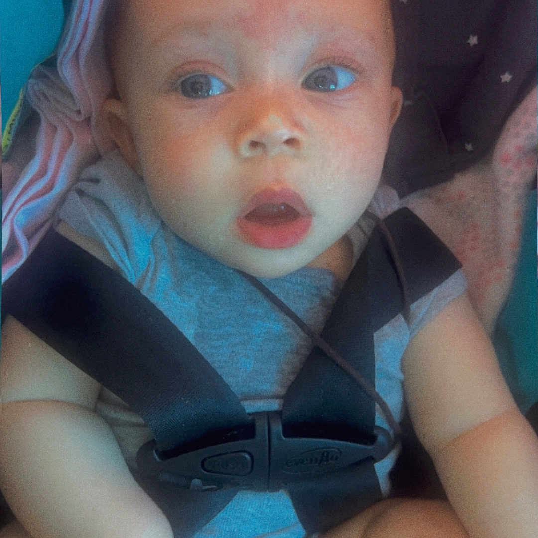 Analaya joined the competition — help win amazing prizes! baby, baby_boy, baby_girl, blanket, car_seat, child, child_seat, clothing, cute, expression, face, head, human_hand, indoor, infant, person, seatbelt, security, sitting, skin