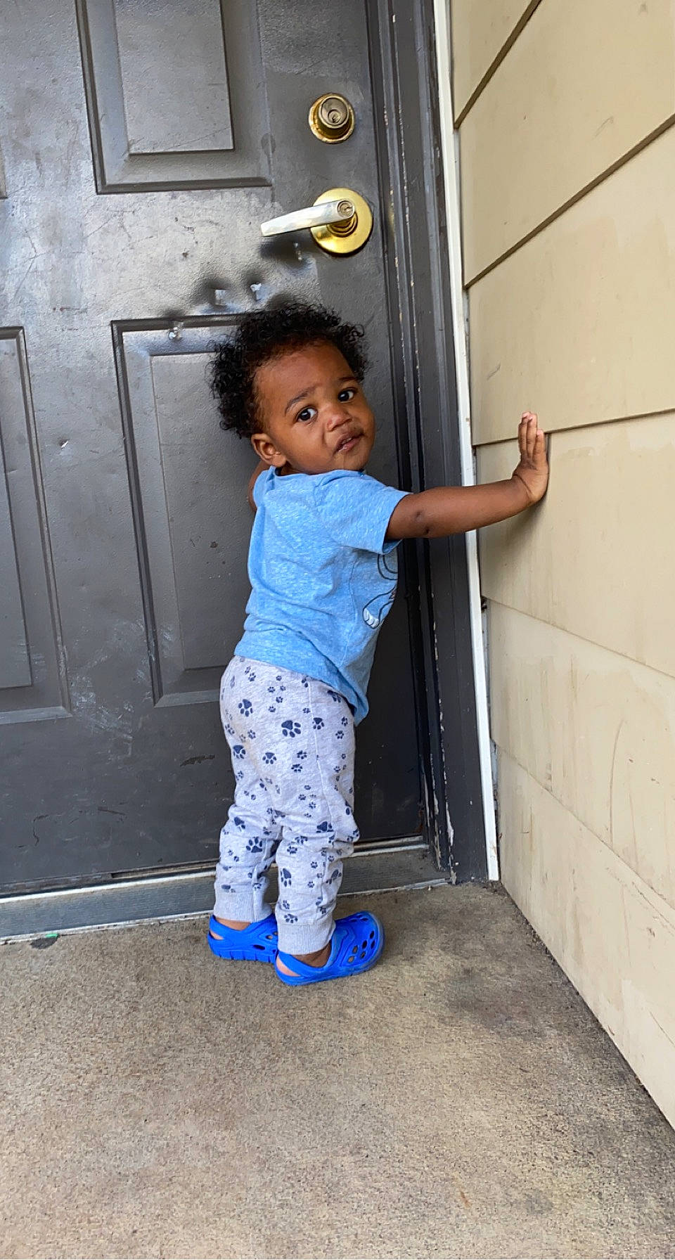 Kameron is registered to the contest to win money with this photo: baby, baby_toddler_clothing, child, door, electric_blue, eye, happy, home_door, human_body, human_leg, leg, line, pattern, person, sitting, sleeve, smile, standing, thigh, toddler