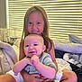 Liam joined the competition — help win amazing prizes! child, baby, smile, indoor, bed, blanket, window_blinds, hugging, sitting, happy, person, clothing, furniture, home, natural_light, cute, toddler, family, portrait, cozy
