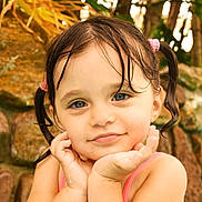 Margaux participe au concours pour gagner de l'argent avec cette photo : child, girl, wet_hair, pigtails, blue_eyes, smiling, cute, portrait, outdoor, nature, greenery, stone_wall, water_drops, tank_top, summer, innocence, face, hands, closeup, happy