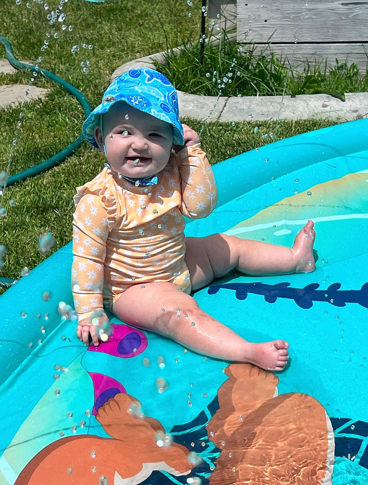 Amelia joined the competition — help win amazing prizes! aqua, baby_toddler_clothing, blue, cap, child, electric_blue, event, fun, grass, green, happy, hat, headwear, leisure, outdoor_play_equipment, person, play, recreation, shorts, smile