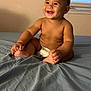 baby, child, smiling, diaper, bed, sheet, indoor, window, window_blinds, skin, happy, cute, infant, person, bare_chest, sitting, young, room, light, portrait