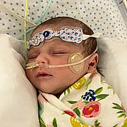 Brynleigh joined the competition — help win amazing prizes! baby, bed, child, cute, face, floral_blanket, head, healthcare, hospital, indoors, infant, medical_tubes, monitoring_patch, newborn, patient, person, polka_dot, resting, sleeping, swaddled