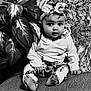 baby, child, headband, barefoot, plant, leaf, sitting, curious, black_and_white, portrait, indoors, soft_texture, clothing, cute, expression, eyes, face, young, floor, cozy