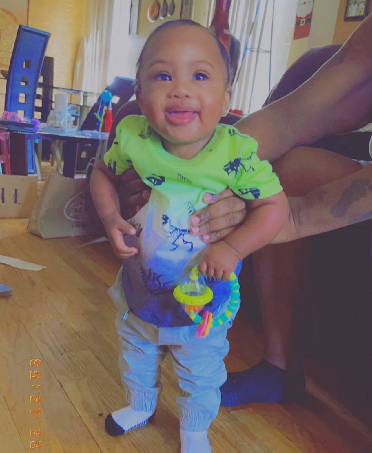 Lamar is registered to the contest to win money with this photo: baby, baby_toddler_clothing, blue, cheek, eye, facial_expression, finger, floor, flooring, fun, happy, head, iris, person, skin, sleeve, smile, standing, thumb, toddler