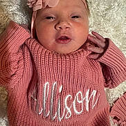 Allison joined the competition — help win amazing prizes! baby, pink, sweater, headband, flower, infant, knitwear, blanket, closeup, cute, child, portrait, soft_texture, newborn, hand, face, lying_down, warm_clothing, indoor, young