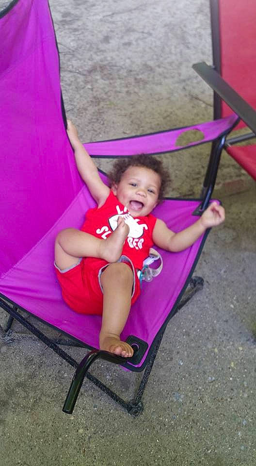 Cecil is registered to the contest to win money with this photo: chair, child, fun, furniture, leisure, magenta, person, pink, play, purple, red, sitting, smile, swing, toddler, vacation, violet