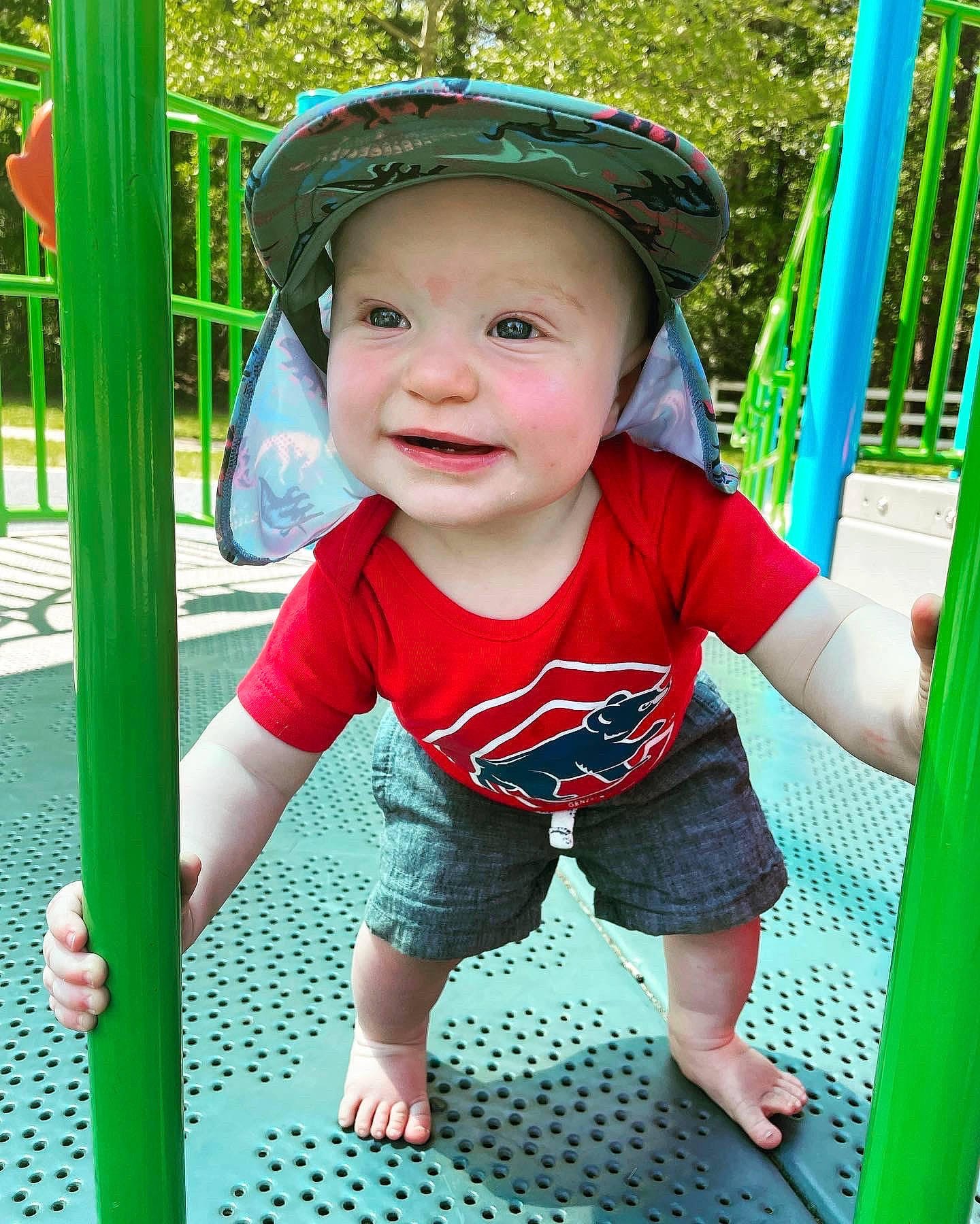 Joe is registered to the contest to win money with this photo: baby, baby_toddler_clothing, cap, child, chute, city, facial_expression, fun, grass, green, happy, headwear, joy, leisure, person, play, playground, recreation, sleeve, smile