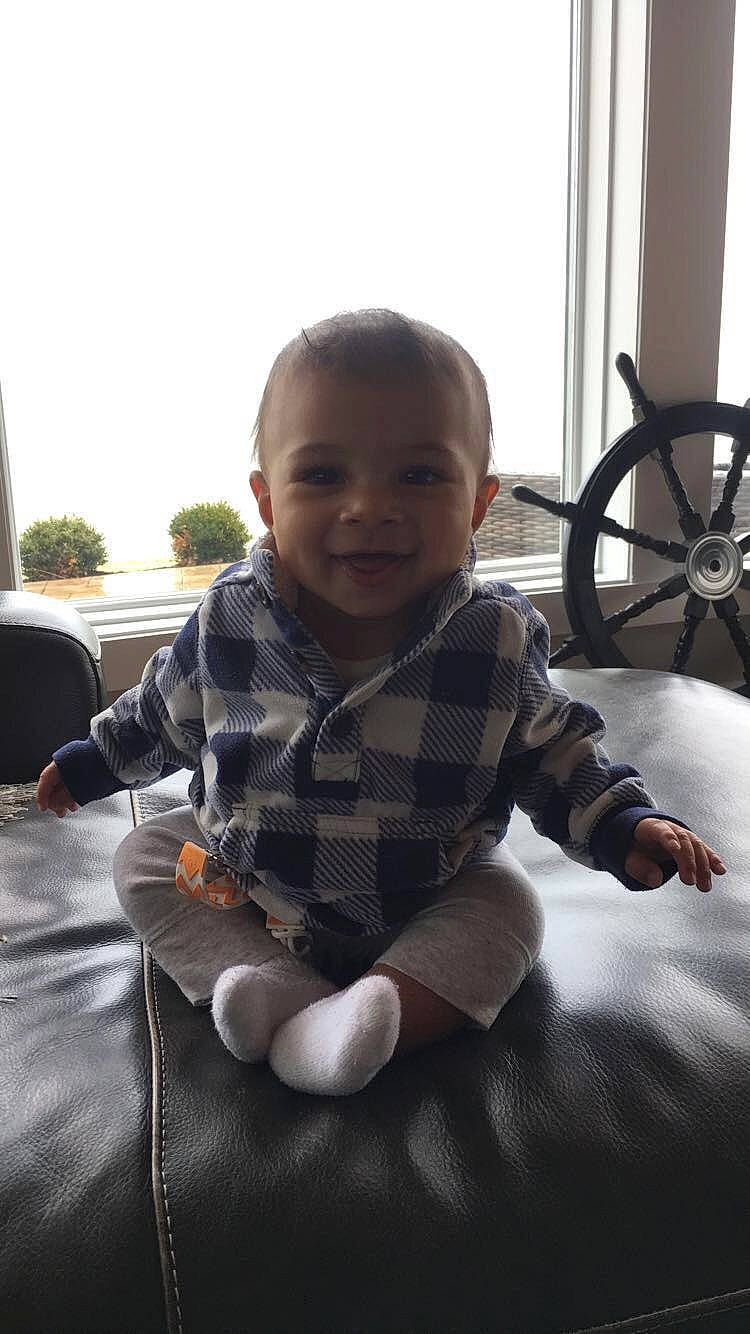 Craig is registered to the contest to win money with this photo: arm, baby, cheek, child, leg, person, play, sitting, smile, toddler