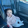 baby, child, infant, smiling, portrait, car, vehicle, car_seat, seated, sweater, pants, clothing, blue, indoors, automotive, leather, window, daylight, face, happy