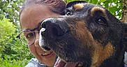 Bounty participe au concours pour gagner de l'argent avec cette photo : dog, person, glasses, outdoor, greenery, trees, smile, tongue_out, happy, selfie, collar, tattoo, nature, face, portrait, canine, animal, closeup, friendship, daylight