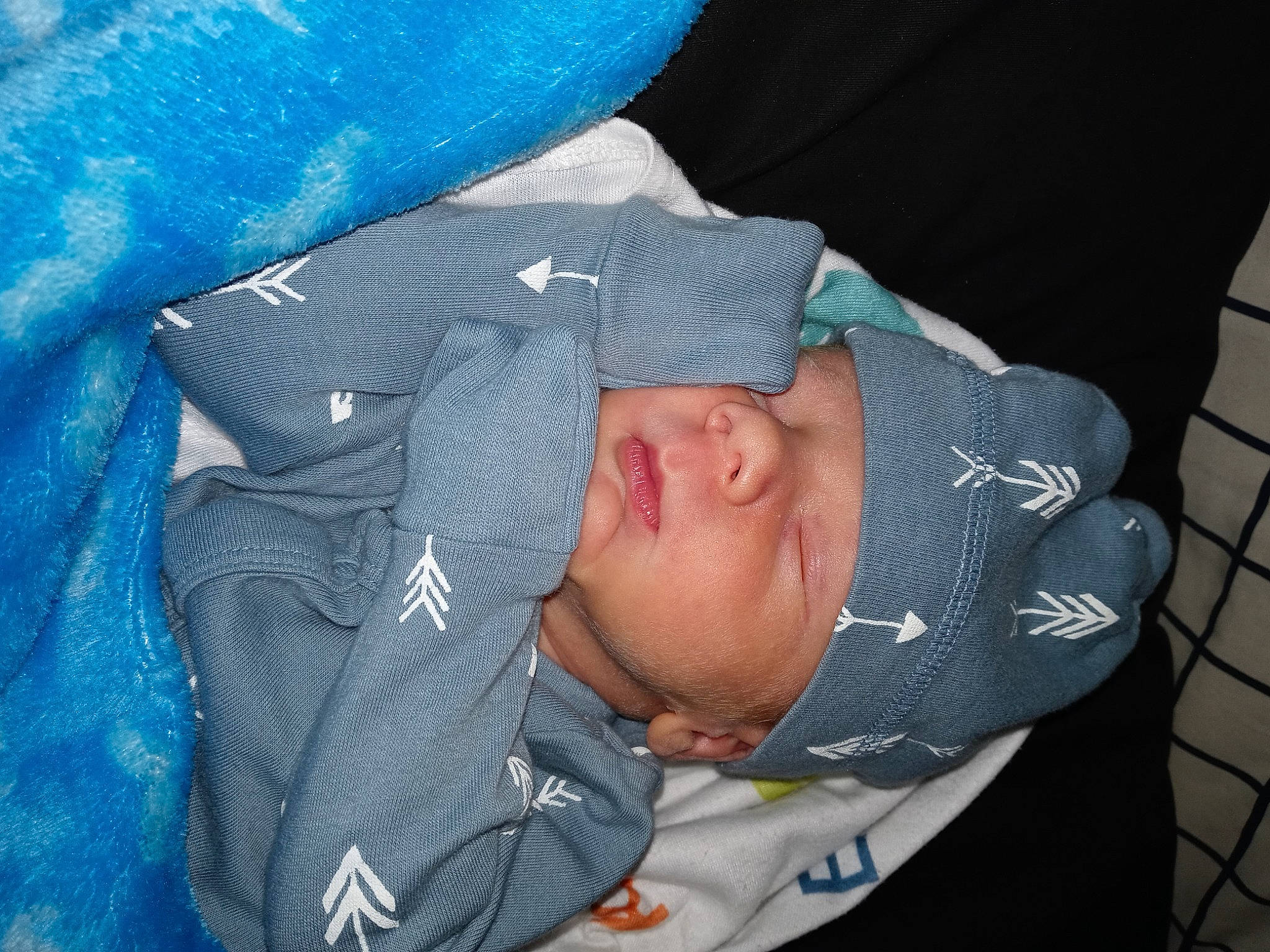 Kyler is registered to the contest to win money with this photo: baby, baby_products, baby_toddler_clothing, blue, child, comfort, electric_blue, headwear, nap, person, sleeve, toddler, tree, winter