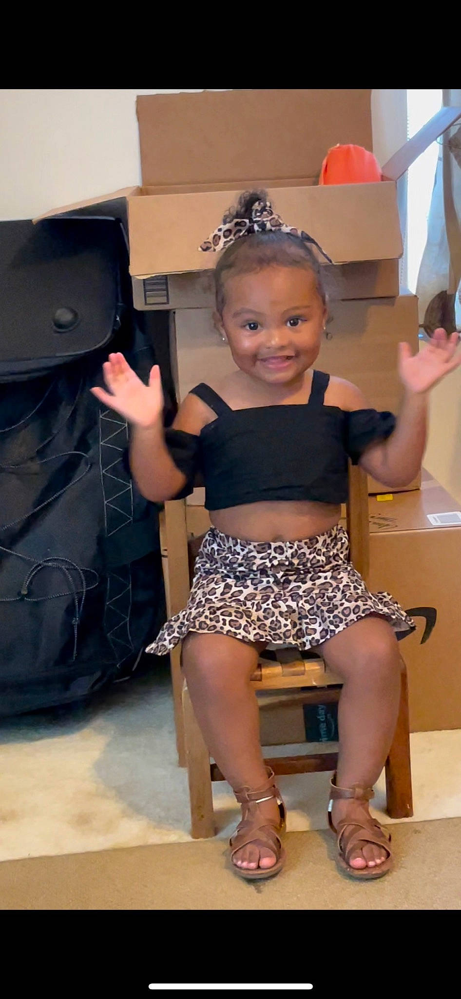 Millie is registered to the contest to win money with this photo: abdomen, chair, chest, finger, fun, happy, human_leg, joint, joy, knee, leg, leisure, neck, person, shoulder, skin, smile, thigh, thumb, toddler