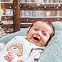 Lenny is registered to the contest to win money with this photo: baby, smiling, infant, cozy, cute, pillow, soft, winter, snow, christmas, holiday, background, wooden_fence, outdoor_scene, warm_clothing, happy, portrait, face, child, festive