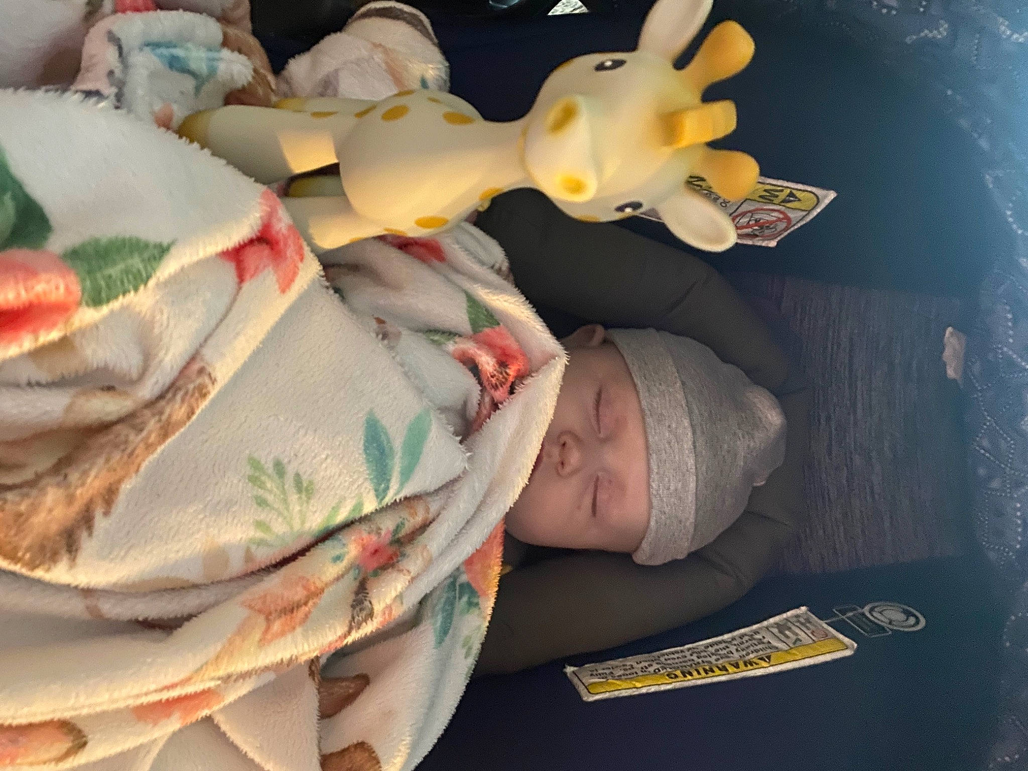 Delilah is registered to the contest to win money with this photo: baby, baby_products, baby_toddler_clothing, carmine, child, comfort, happy, hat, head, headgear, headwear, linens, pattern, peach, person, room, toddler