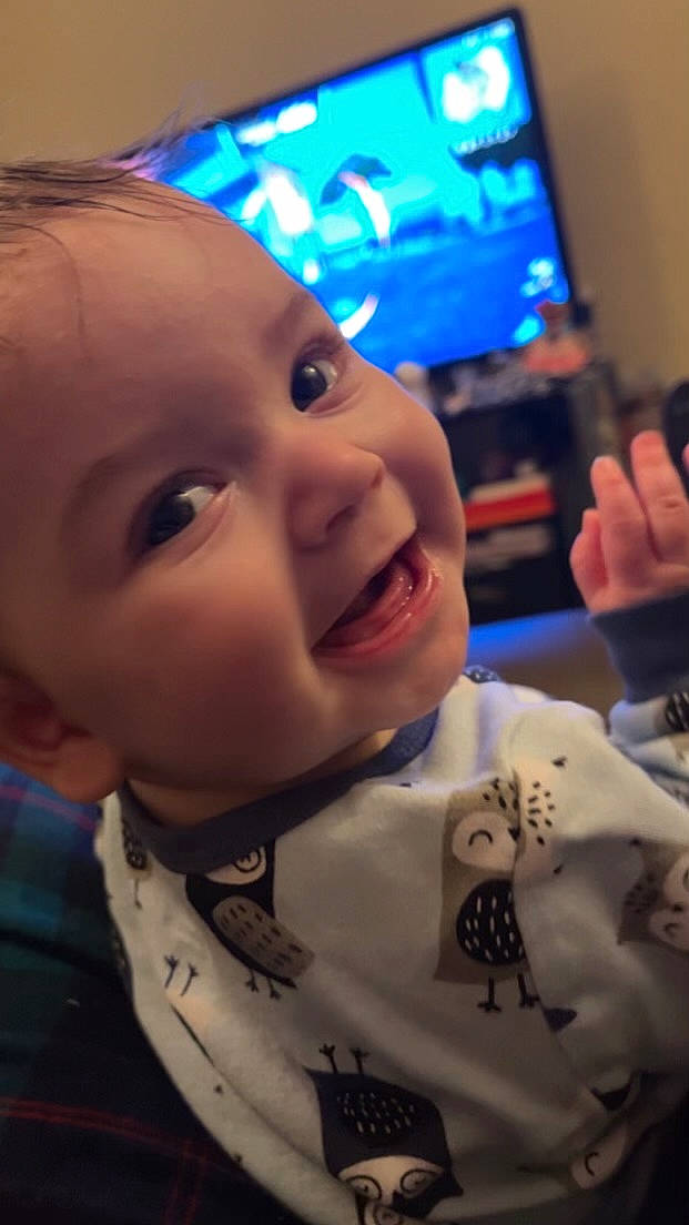 Grayson is registered to the contest to win money with this photo: baby, blue, cheek, chin, cool, ear, eyebrow, facial_expression, finger, hairstyle, happy, human, iris, mouth, nose, people, person, skin, smile, television