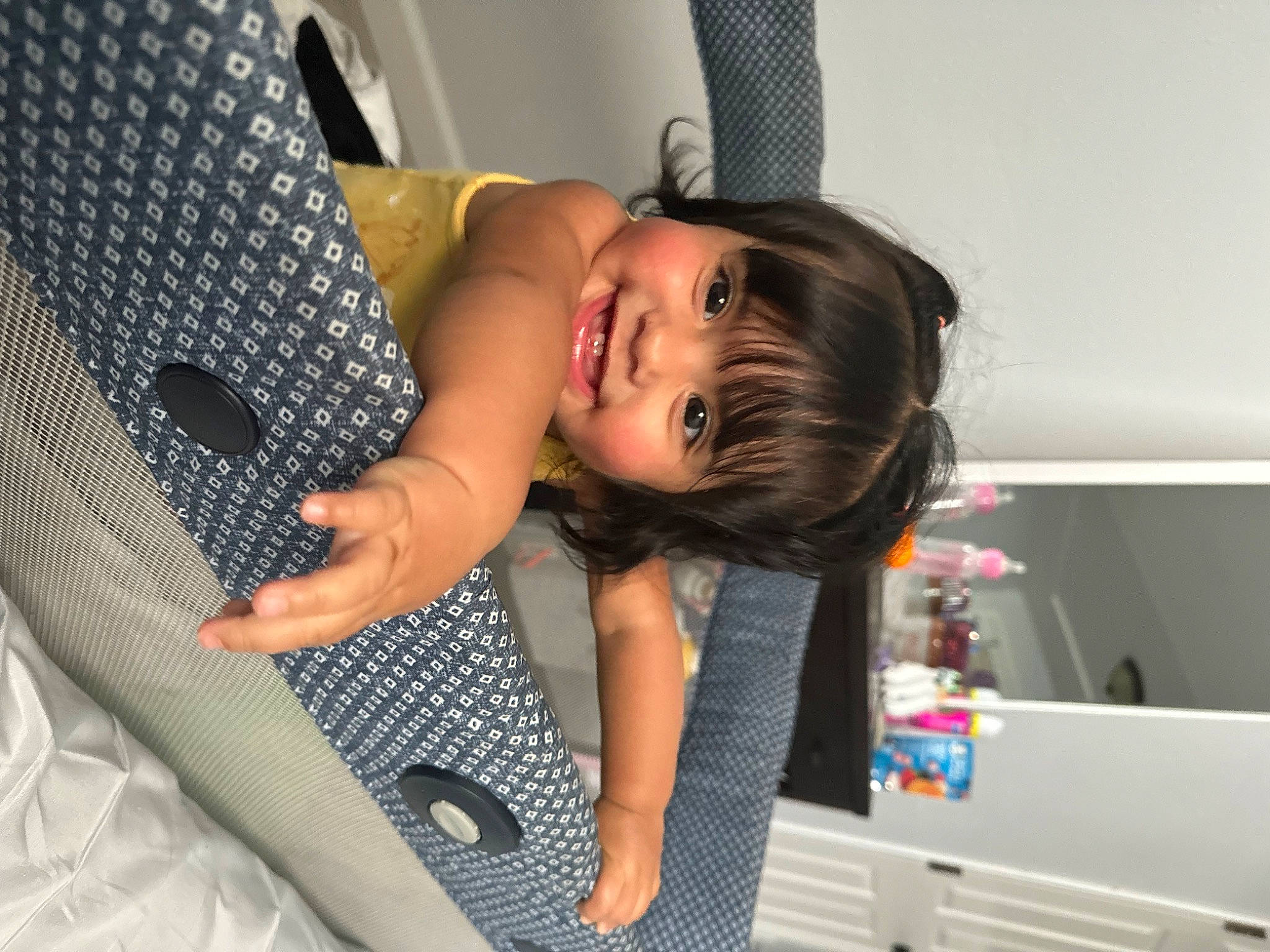 Jaylani is registered to the contest to win money with this photo: arm, baby, baby_products, baby_safety, baby_toddler_clothing, car_seat, child, comfort, fun, hairstyle, happy, joy, pattern, person, product, room, sitting, smile, toddler, vacation