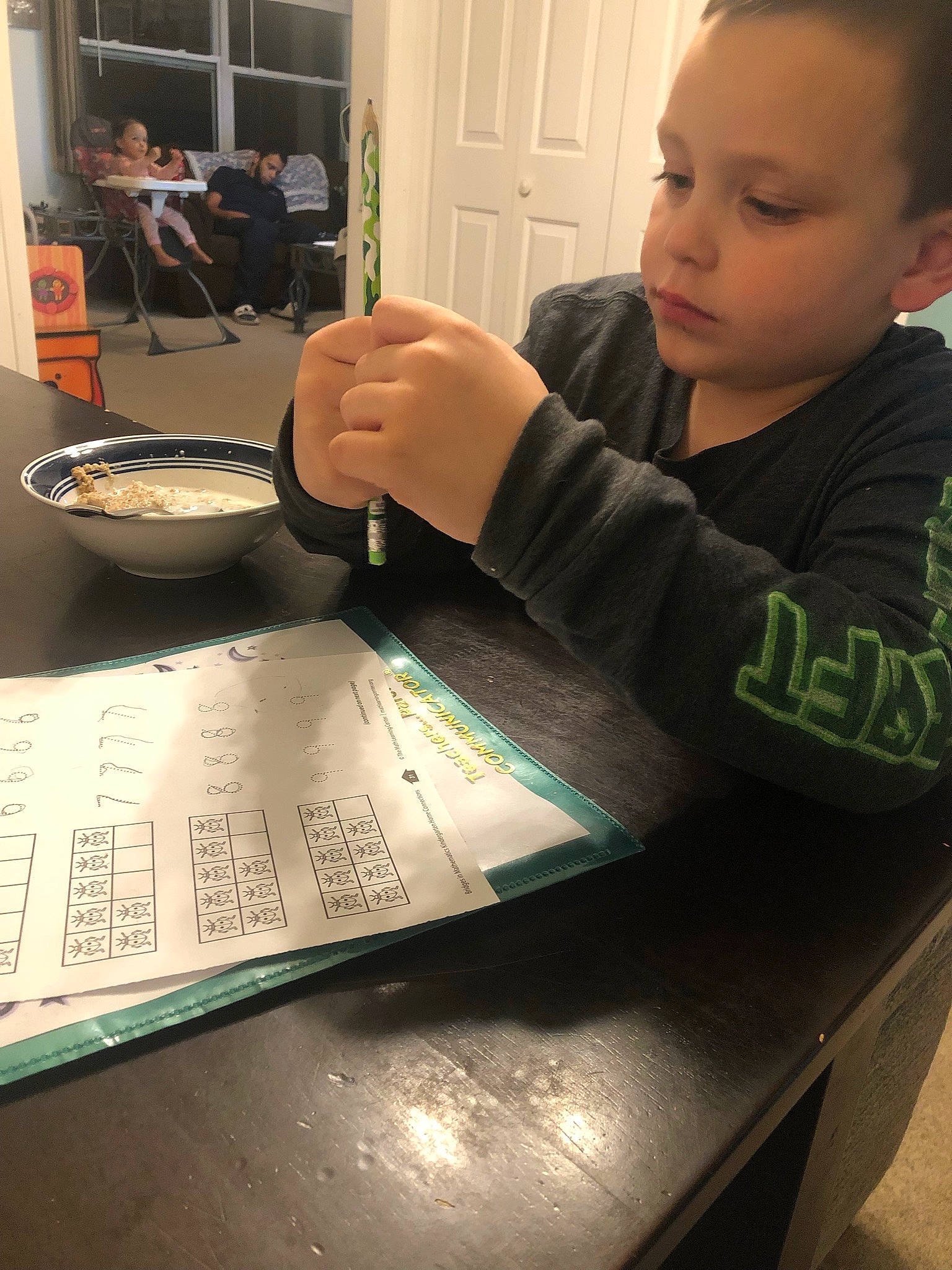 Jaxson is registered to the contest to win money with this photo: artist, chair, comfort_food, desk, font, gadget, handwriting, job, learning, person, plate, room, sitting, t_shirt, table, tableware, thumb, toddler, visual_arts, writing