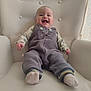 baby, child, smiling, armchair, overalls, socks, happy, indoor, cute, portrait, infant, clothing, furniture, seated, person, home, cozy, fabric, button, face