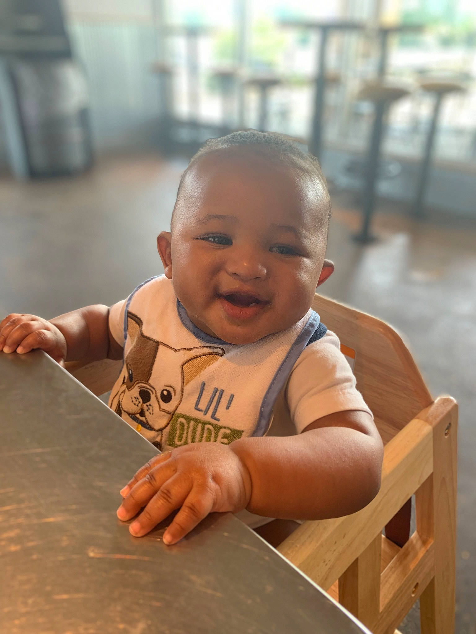 Nori is registered to the contest to win money with this photo: baby, baby_toddler_clothing, chair, cheek, child, eye, flooring, fun, happy, hardwood, human_body, leisure, person, recreation, sitting, skin, smile, thumb, toddler, vacation