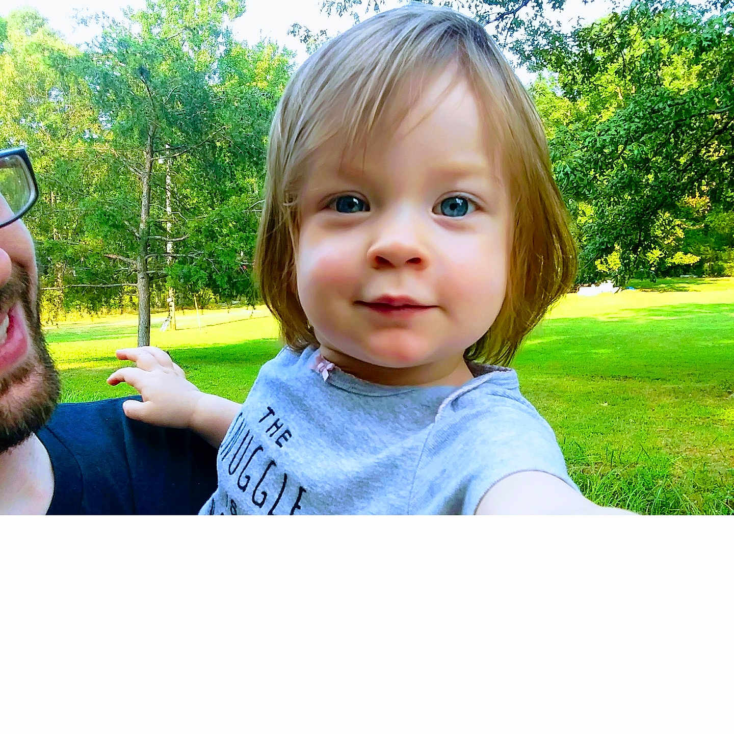 Emmaleigh is registered to the contest to win money with this photo: accessories, baby, clothing, face, glasses, grass, grove, head, land, nature, outdoors, park, person, photography, plant, portrait, t_shirt, tree, vegetation, woodland