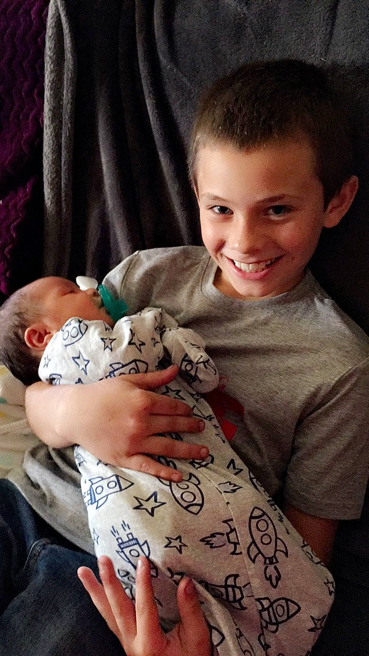 Marlon is registered to the contest to win money with this photo: arm, baby, birth, child, joy, person, tattoo, toddler