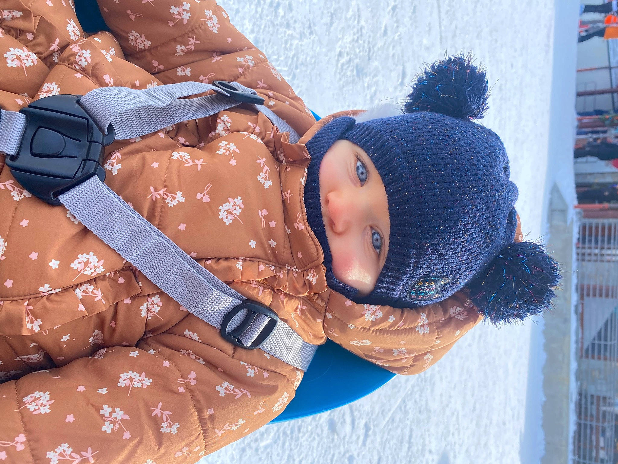 Mila participe au concours pour gagner de l'argent avec cette photo : baby, beanie, cap, child, comfort, electric_blue, fashion_accessory, freezing, fun, fur, headwear, knit_cap, pattern, person, sleeve, snow, textile, toddler, toy, tree