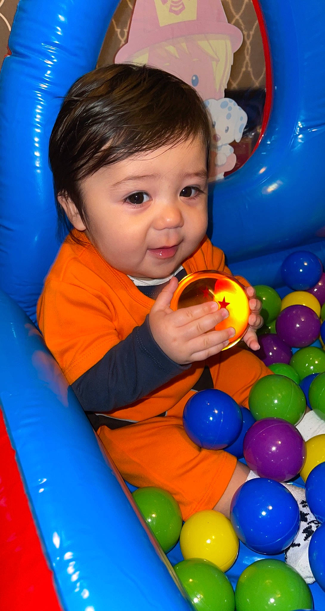 Manuel joined the competition — help win amazing prizes! baby_playing_with_toys, ball, ball_pit, black, blue, child, face, fun, happy, human_settlement, leisure, orange, organ, person, photograph, playground, public_space, recreation, snapshot, toddler