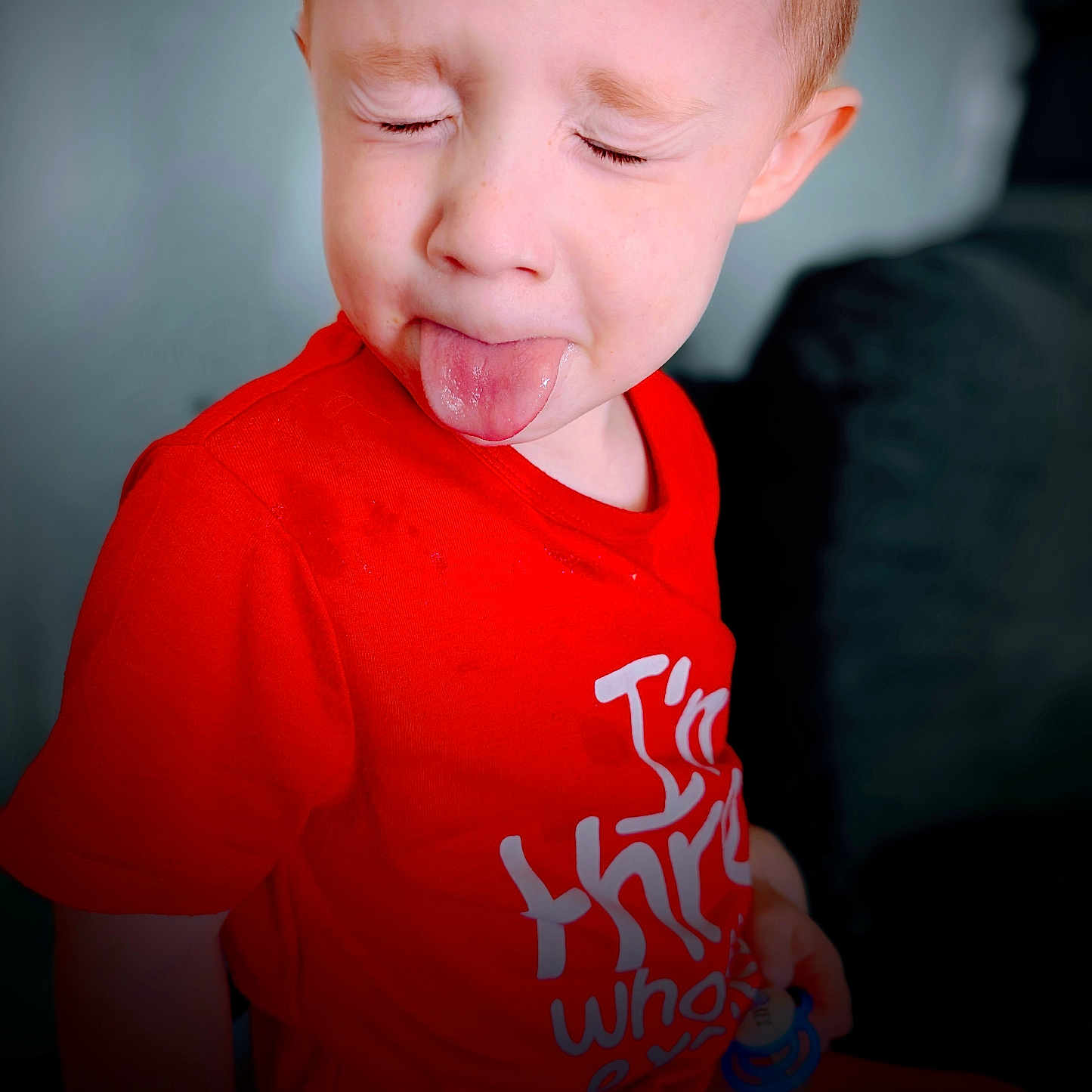 Keaghan joined the competition — help win amazing prizes! baby, bodypart, clothing, couch, eating, face, finger, food, furniture, hand, head, mouth, person, photography, portrait, shirt, spitting, sweets, t_shirt, tongue