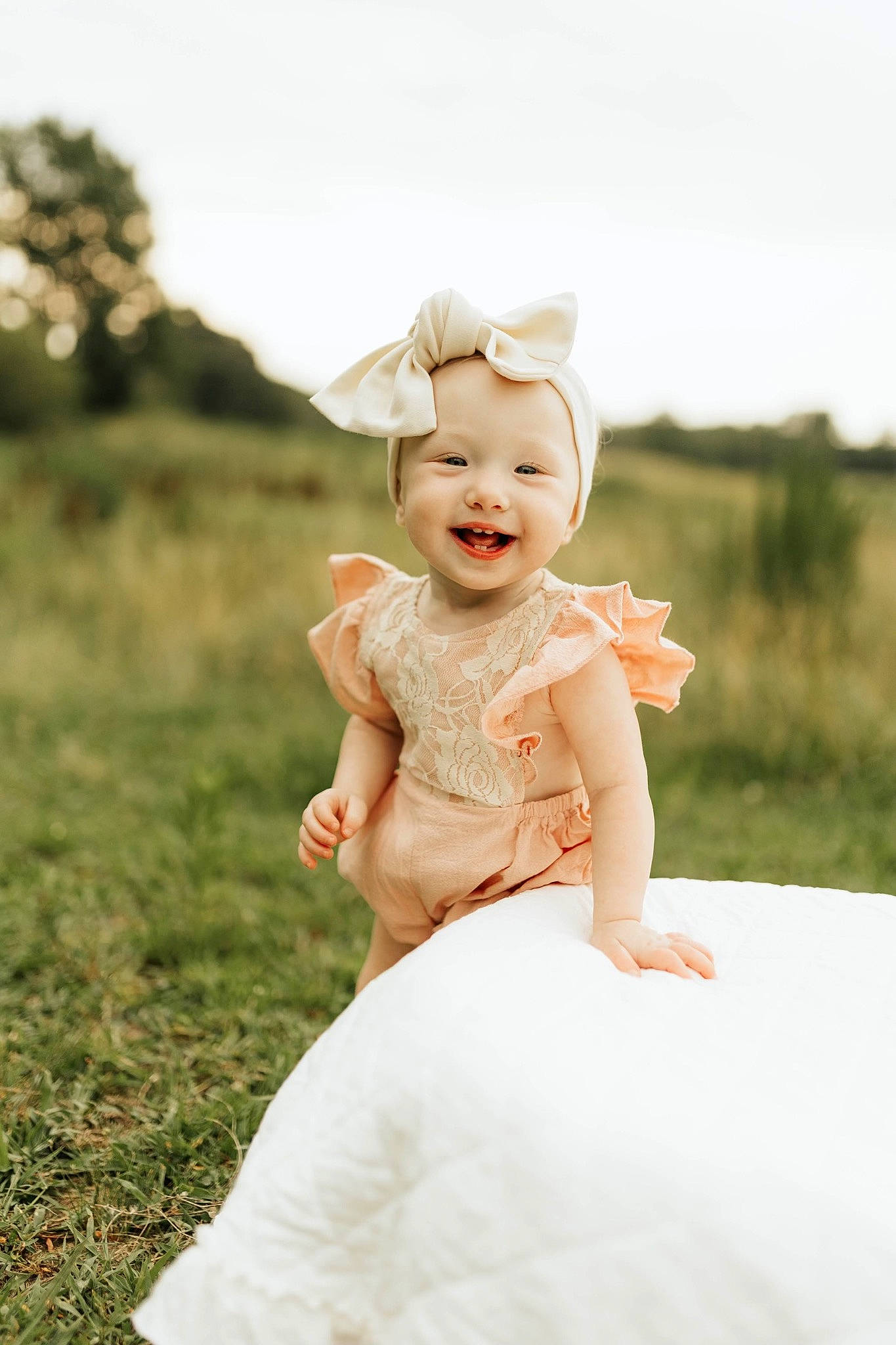 Brynleigh is registered to the contest to win money with this photo: baby, baby_toddler_clothing, child, dress, flash_photography, fun, gesture, grass, grassland, happy, hat, headwear, joy, peach, people_in_nature, person, portrait_photography, sitting, skin, sky