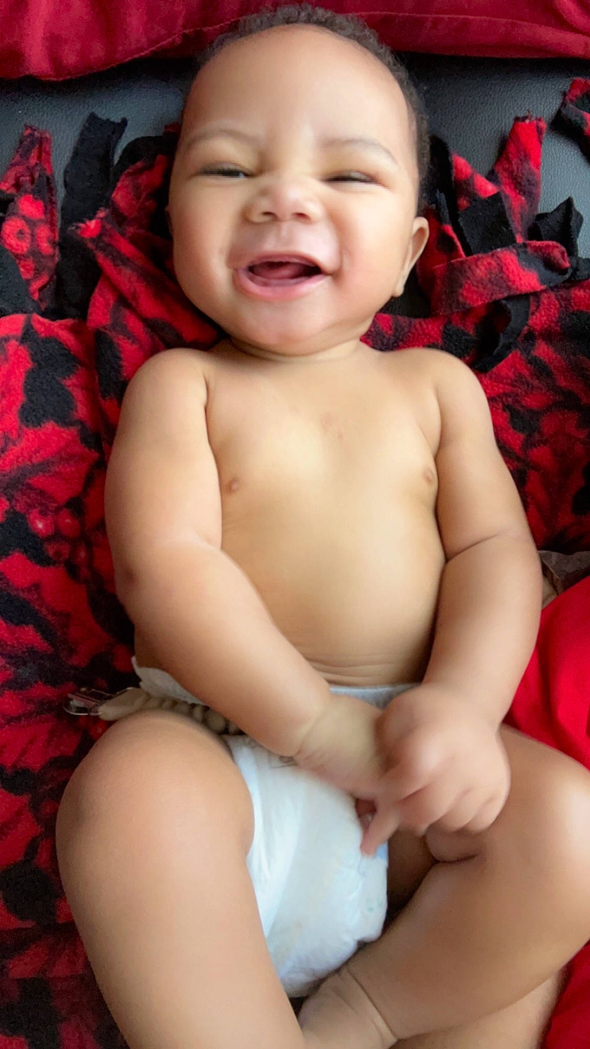 Zyon is registered to the contest to win money with this photo: baby, baby_toddler_clothing, cheek, chest, comfort, eye, finger, happy, head, iris, lip, mouth, muscle, neck, nose, person, pink, skin, smile, stomach