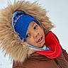 child, winter, portrait, smiling, face, blue_hat, red_scarf, brown_coat, fur_hood, winter_clothing, outdoor, snow, cold_weather, bundled_up, happy, close_up, person, knitwear, jacket, photography
