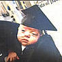 baby, infant, graduation_cap, black_gown, nasal_tube, person, child, celebration, portrait, indoor, holding, face, headwear, medical, closeup, young_child, human, gown, event, candid