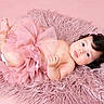 adorable, baby, bare_chest, child, curly_hair, cute, fluffy_rug, hair_clip, indoor, infant, lying_down, pastel, pink, portrait, skin, small_feet, soft_texture, studio_photo, tutu, young_child
