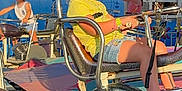 Nevaeh joined the competition — help win amazing prizes! amusement_park, background, child, clothing, daytime, fun, girl, happiness, kids, motorbike, outdoor, pigtails, play, ride, sandals, seat, shorts, smile, summer, sunlight