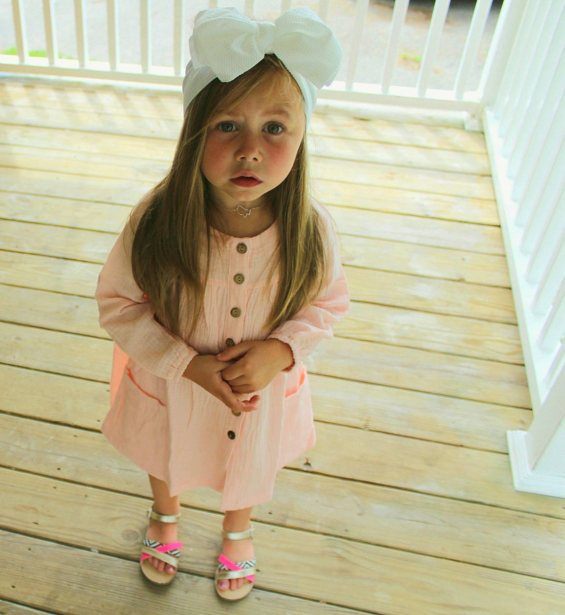 Natalie is registered to the contest to win money with this photo: beanie, beauty, beige, cap, child, child_model, clothing, fashion_accessory, headgear, hood, lip, long_hair, outerwear, peach, person, pink, skin, sleeve, t_shirt, toddler