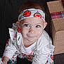 toddler, child, face, headband, holiday_clothing, gift_box, smile, blue_eyes, white_shirt, festive, indoor, cute, person, portrait, sitting, young_child, holiday_season, wrapped_present, apparel, headwear
