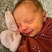Violet is registered to the contest to win money with this photo: newborn, baby, sleeping, smile, mitt, blanket, cozy, face, head, infant, clothing, pattern, stars, moon, soft, cute, rest, peaceful, portrait, closeup