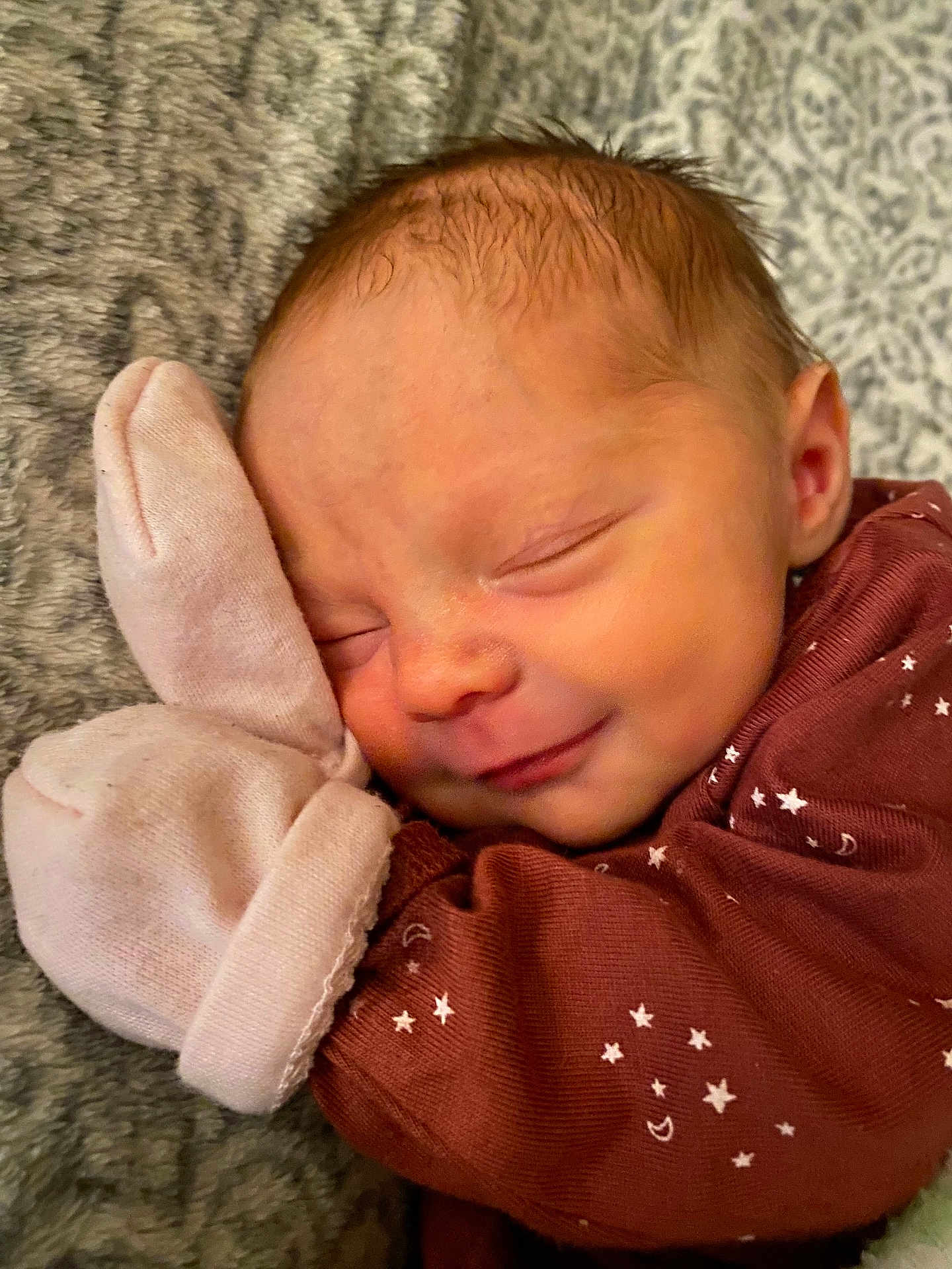 Violet is registered to the contest to win money with this photo: newborn, baby, sleeping, smile, mitt, blanket, cozy, face, head, infant, clothing, pattern, stars, moon, soft, cute, rest, peaceful, portrait, closeup