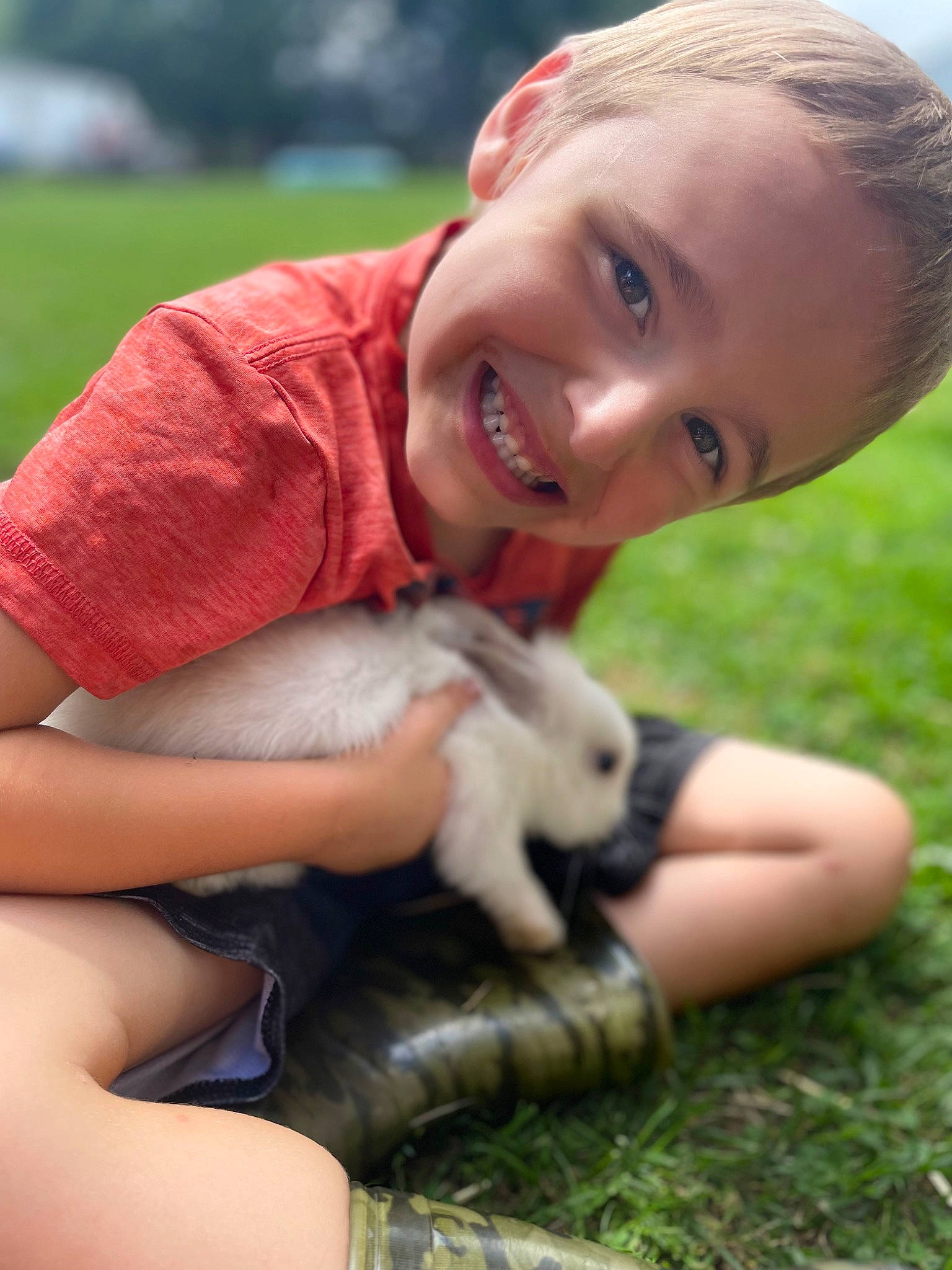 Dakota is registered to the contest to win money with this photo: blond, child, facial_expression, fawn, finger, fun, grass, grass_family, grassland, happy, human_leg, joy, lawn, leisure, mammal, people_in_nature, person, skin, smile, thumb