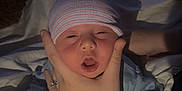 Brandon joined the competition — help win amazing prizes! newborn, baby, infant, hat, hand, blanket, bed, sleepwear, person, skin, face, mouth, fingers, soft_light, cozy, indoors, portrait, cute, tiny, resting
