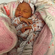 Rhaelynn joined the competition — help win amazing prizes! baby, newborn, sleeping, blanket, headband, bow, floral_pattern, animal_pattern, pink, white, cozy, wrapped, infant, cute, soft_texture, bed, peaceful, portrait, child, nursery