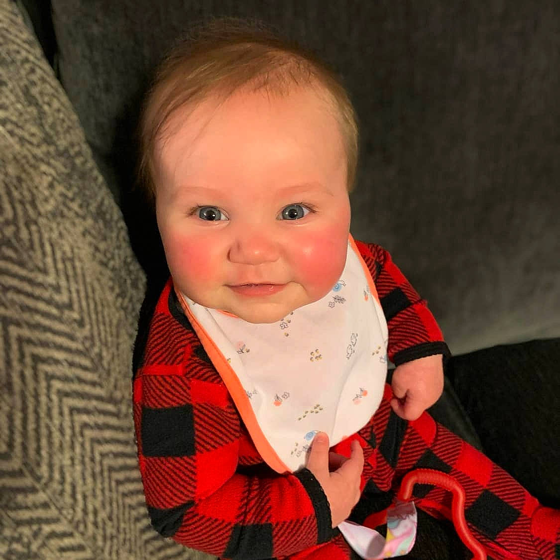Liberty is registered to the contest to win money with this photo: baby, cheek, child, child_model, design, eye, face, head, iris, lip, nose, outerwear, pattern, person, photography, plaid, sitting, skin, tartan, textile